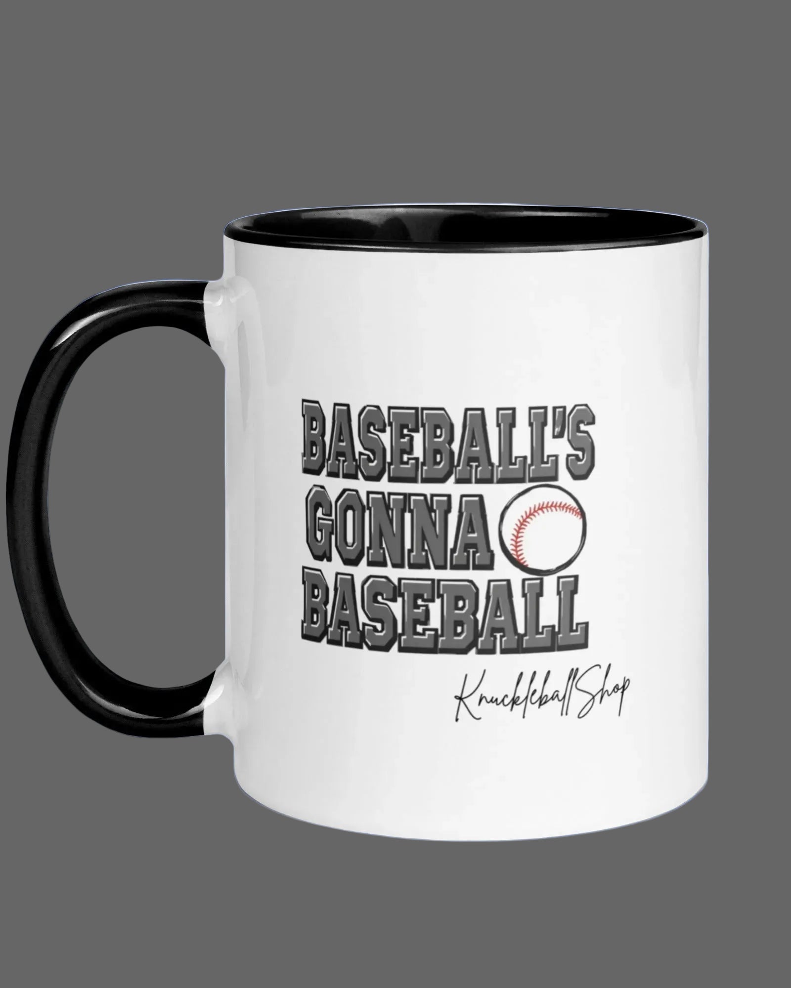 White coffee mug with black handle and black inside, Baseball's Gonna Baseball saying and signature