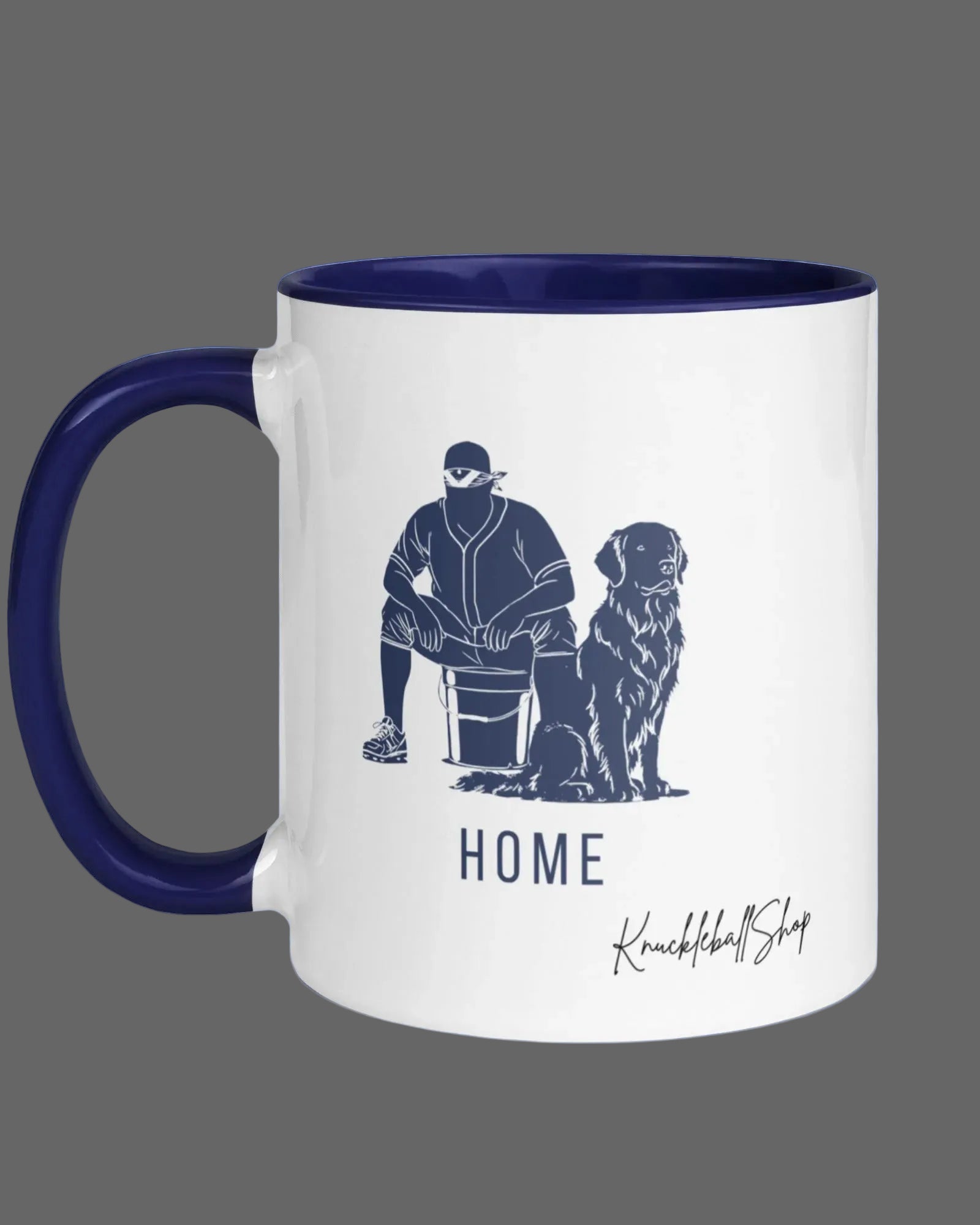 White coffee mug with blue handle and blue inside, "Home" featuring outline of player and his buddy, the team dog and signature