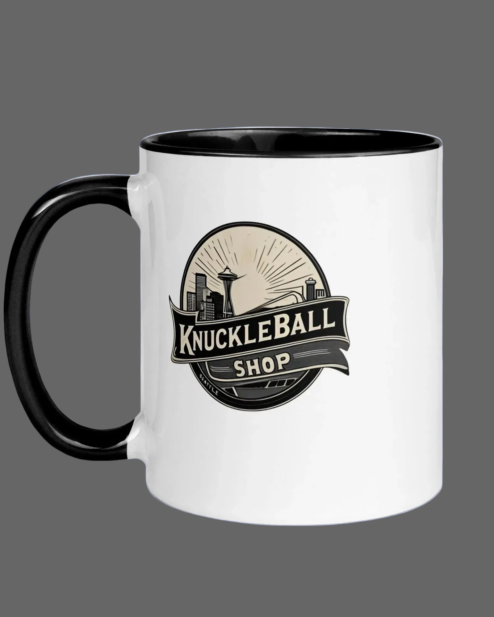White mug with black handle featuring 'Knuckleball Shop' logo on a gray background