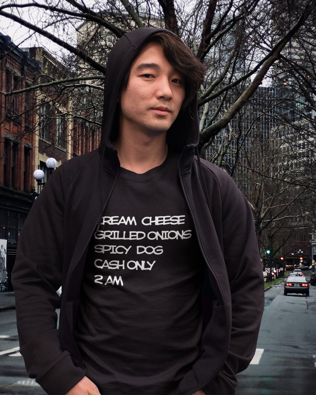 Person wearing a black hoodie and black t-shirt with Seattle Dog recipe standing in Pioneer Square