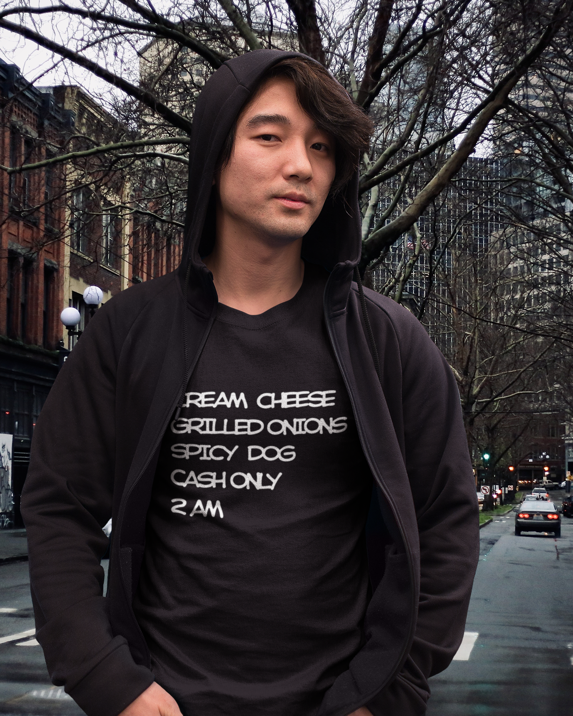 Person wearing a black hoodie and black t-shirt with Seattle Dog recipe standing in Pioneer Square