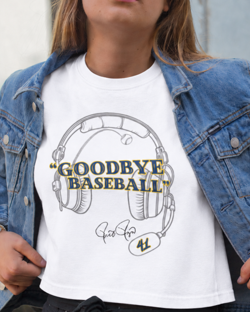 Close-up of a model in a white boxy tee with a headset graphic and blue-and-yellow “Goodbye Baseball” text, and a denim jacket.