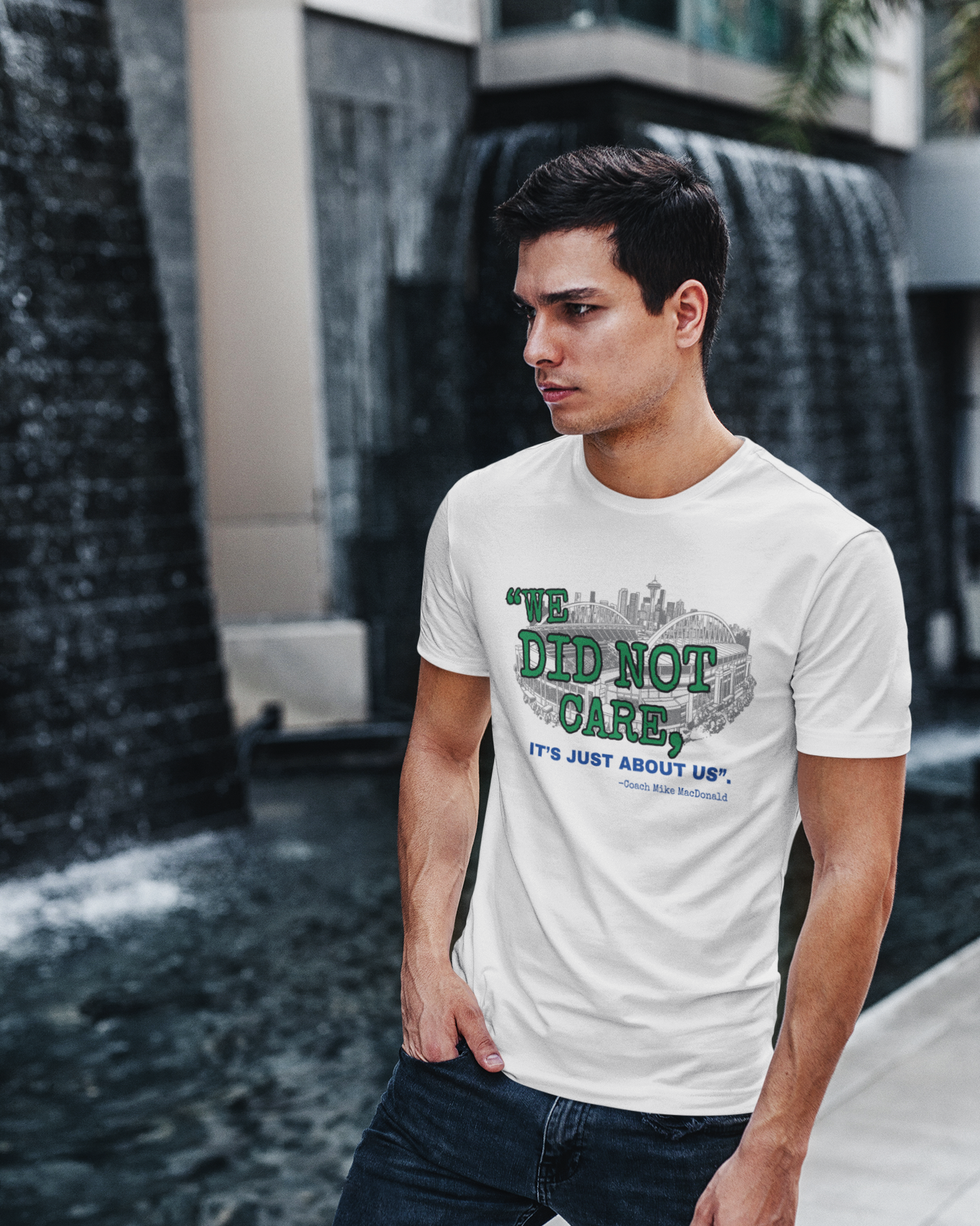 Young man standing on sidewalk with white t-shirt and design saying "We Did Not Care"