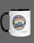 White mug with black inside and black handle featuring a spring training emblem, blue truck, trident and Seattle license plate with signature