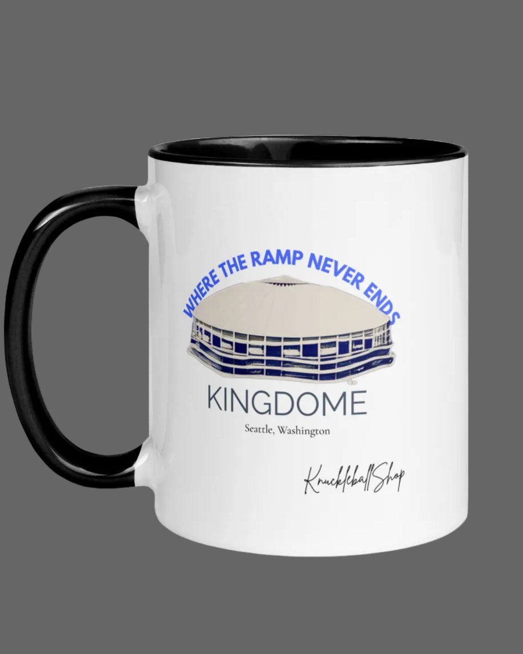 White mug with black inside and black handle featuring  the Kingdome with signature